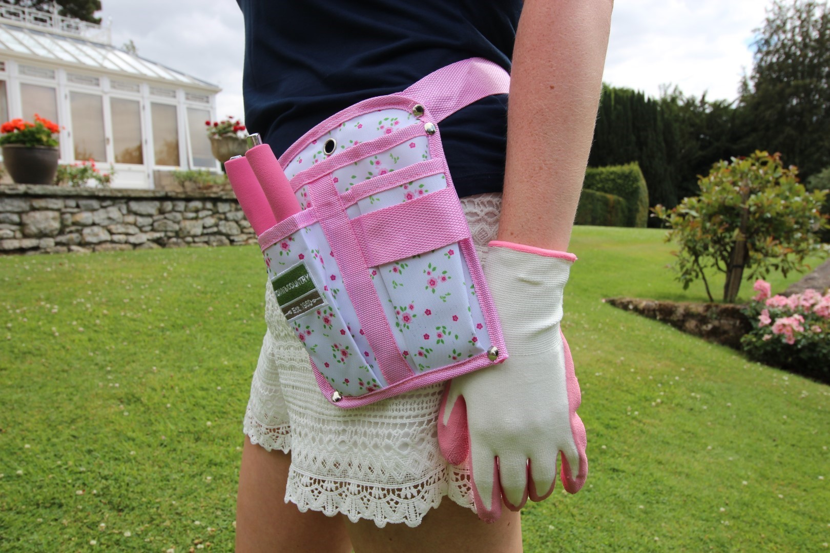 Woman wearing a gardening pouch